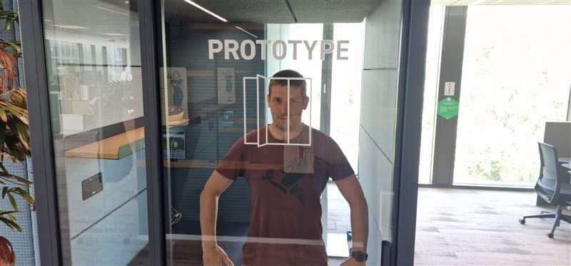 Man inside office behind glass door labeled 'PROTOTYPE'.